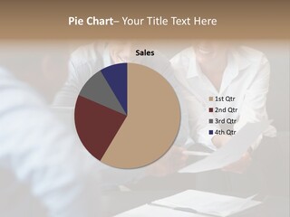 A Couple Of People Sitting At A Table With Papers PowerPoint Template