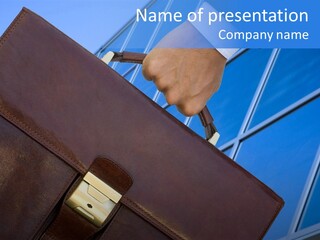 A Person Holding A Briefcase In Front Of A Building PowerPoint Template