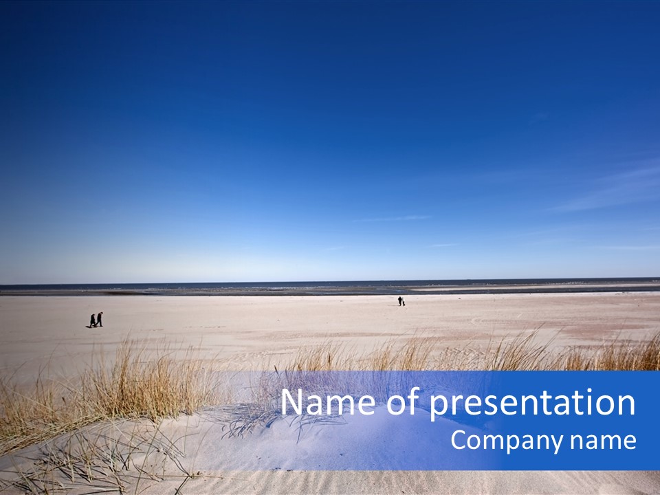 A Sandy Beach With A Person Walking On It PowerPoint Template