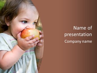 A Little Girl Holding An Apple In Her Hands PowerPoint Template