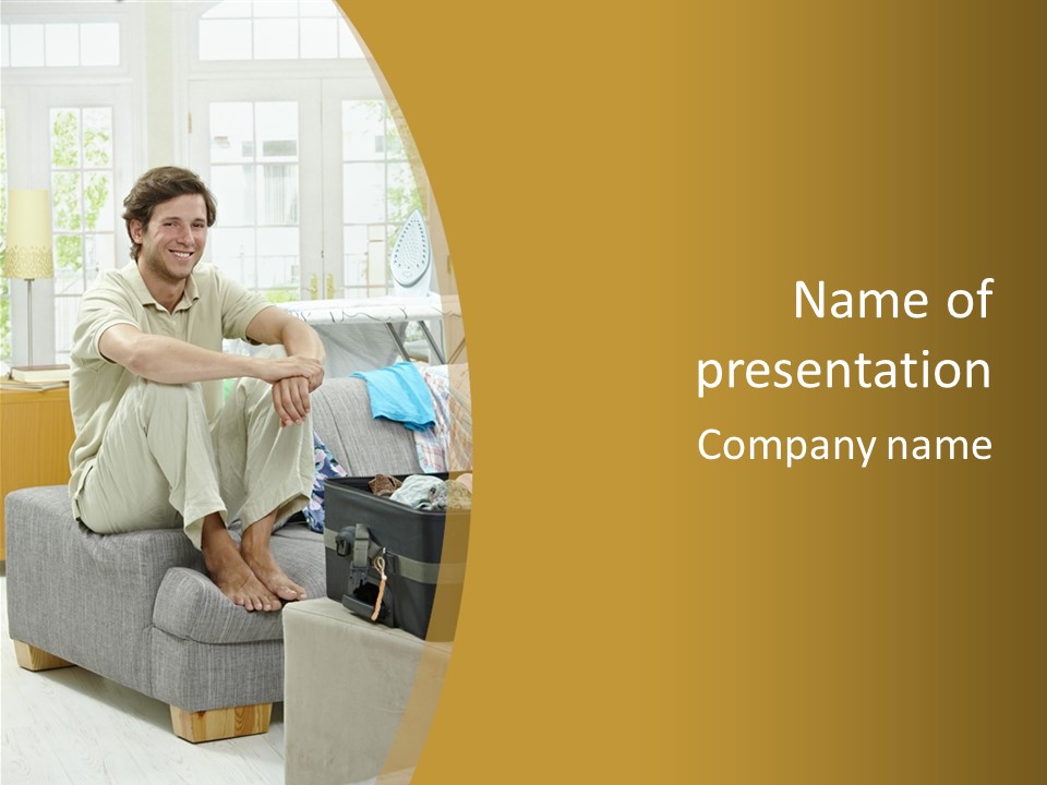A Man Sitting On A Couch In A Living Room PowerPoint Template