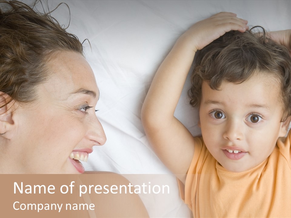 A Woman And A Child Laying In Bed Together PowerPoint Template