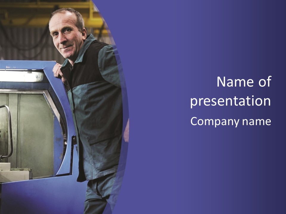 A Man Standing Next To A Machine In A Factory PowerPoint Template