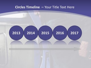 A Man Standing Next To A Machine In A Factory PowerPoint Template