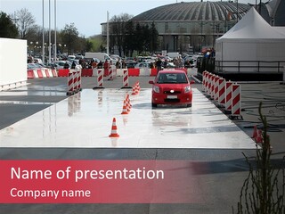 A Red Car Driving Down A Road Surrounded By Traffic Cones PowerPoint Template