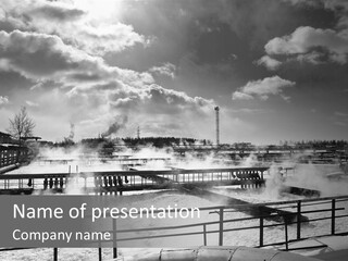 A Black And White Photo Of A Factory With Steam Coming Out Of It PowerPoint Template