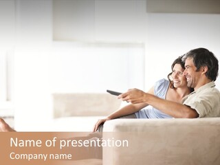 A Man And Woman Sitting On A Couch With A Remote Control PowerPoint Template