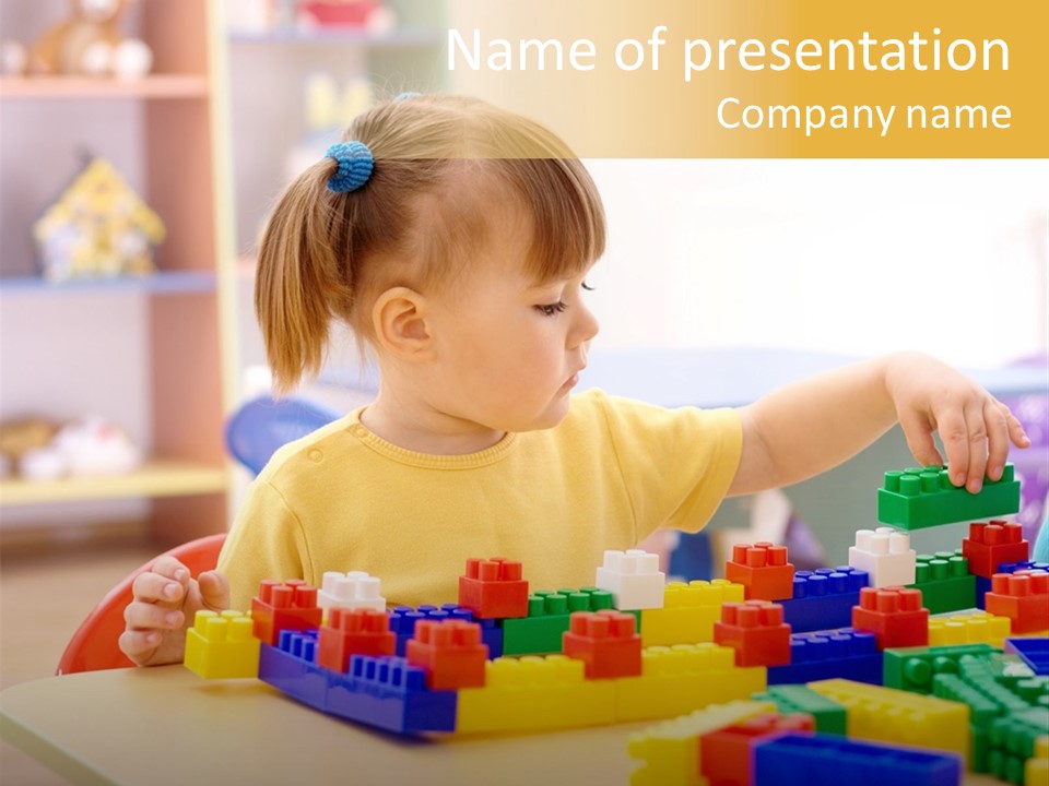 A Little Girl Playing With Legos At A Table PowerPoint Template