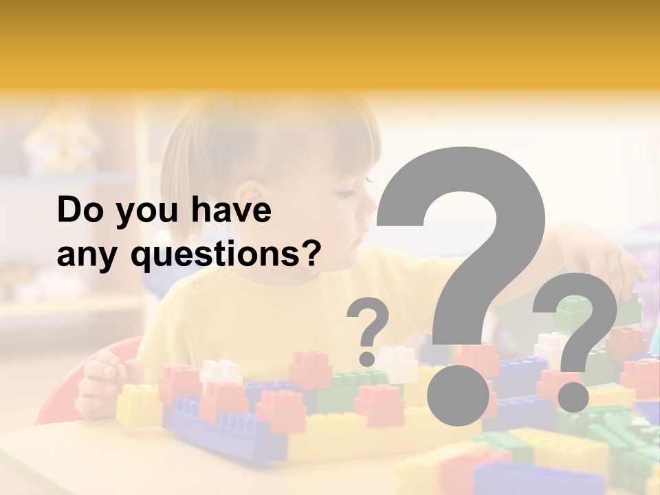A Little Girl Playing With Legos At A Table PowerPoint Template
