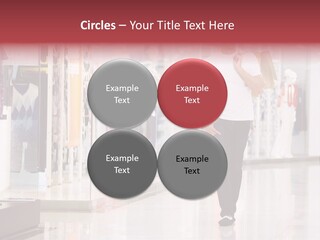 A Man Walking Down A Shopping Mall Holding A Shopping Bag PowerPoint Template