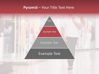 A Man Walking Down A Shopping Mall Holding A Shopping Bag PowerPoint Template