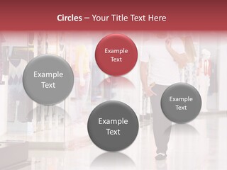 A Man Walking Down A Shopping Mall Holding A Shopping Bag PowerPoint Template