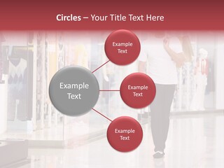 A Man Walking Down A Shopping Mall Holding A Shopping Bag PowerPoint Template