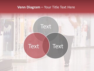 A Man Walking Down A Shopping Mall Holding A Shopping Bag PowerPoint Template