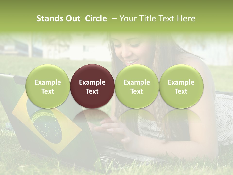 A Woman Laying On The Grass Using A Laptop Computer PowerPoint Template