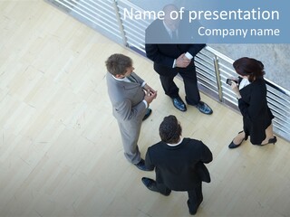 A Group Of People Standing Around A Wooden Floor PowerPoint Template