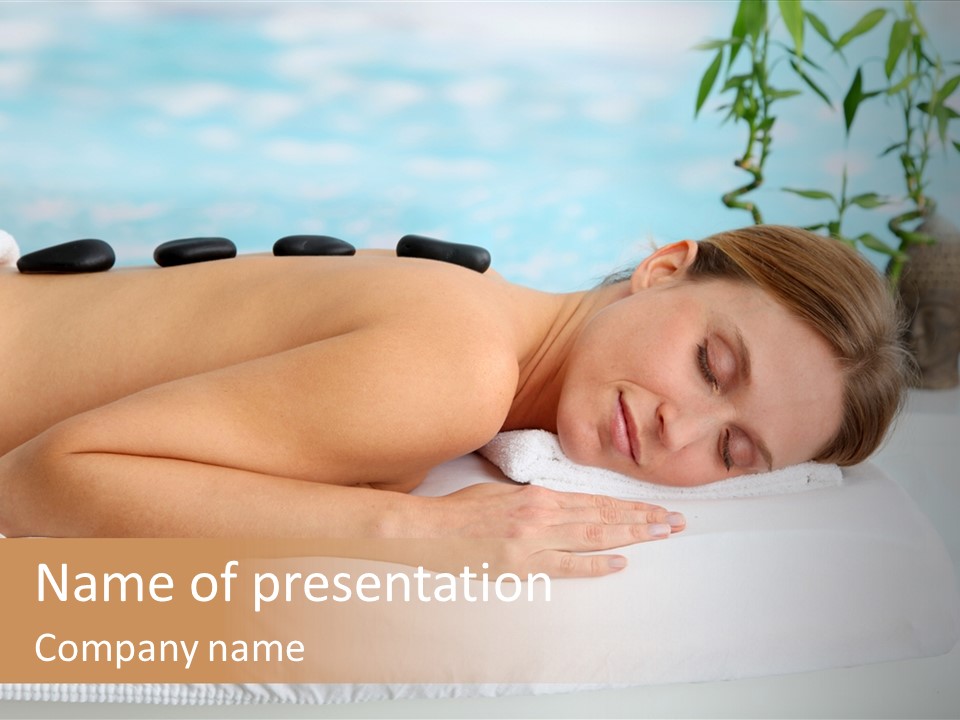 A Woman Laying Down In A Spa With Hot Stones On Her Back PowerPoint Template