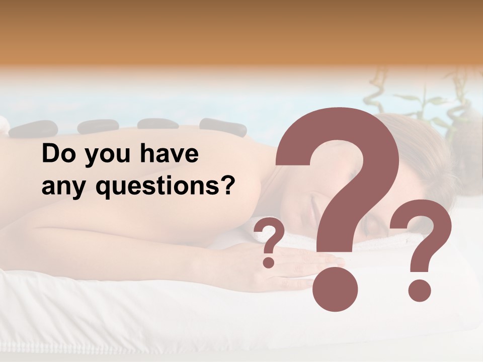 A Woman Laying Down In A Spa With Hot Stones On Her Back PowerPoint Template
