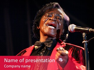 A Woman Singing Into A Microphone On Stage PowerPoint Template