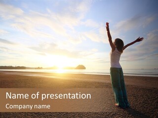 A Woman Standing On A Beach With Her Arms In The Air PowerPoint Template