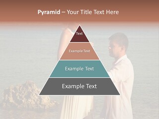A Man And Woman Standing On A Beach Holding Hands PowerPoint Template