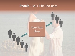 A Man And Woman Standing On A Beach Holding Hands PowerPoint Template