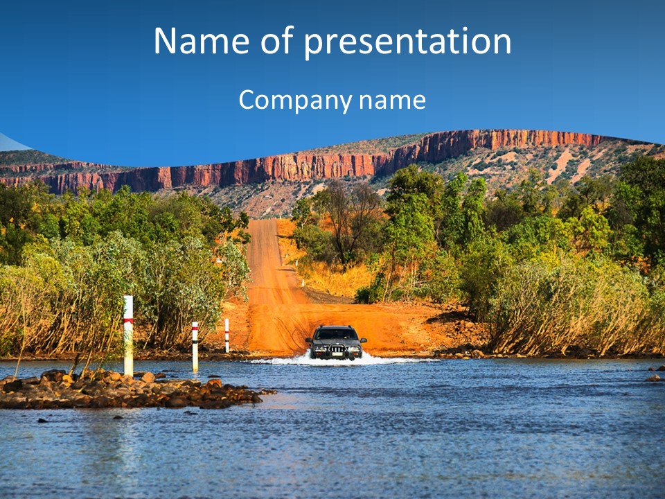 A Truck Driving Down A River With Mountains In The Background PowerPoint Template