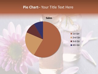 A Bottle Of Oil And A Flower On A Table PowerPoint Template