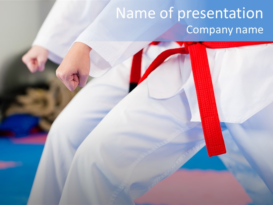 A Person In A Karate Stance With A Red Belt PowerPoint Template