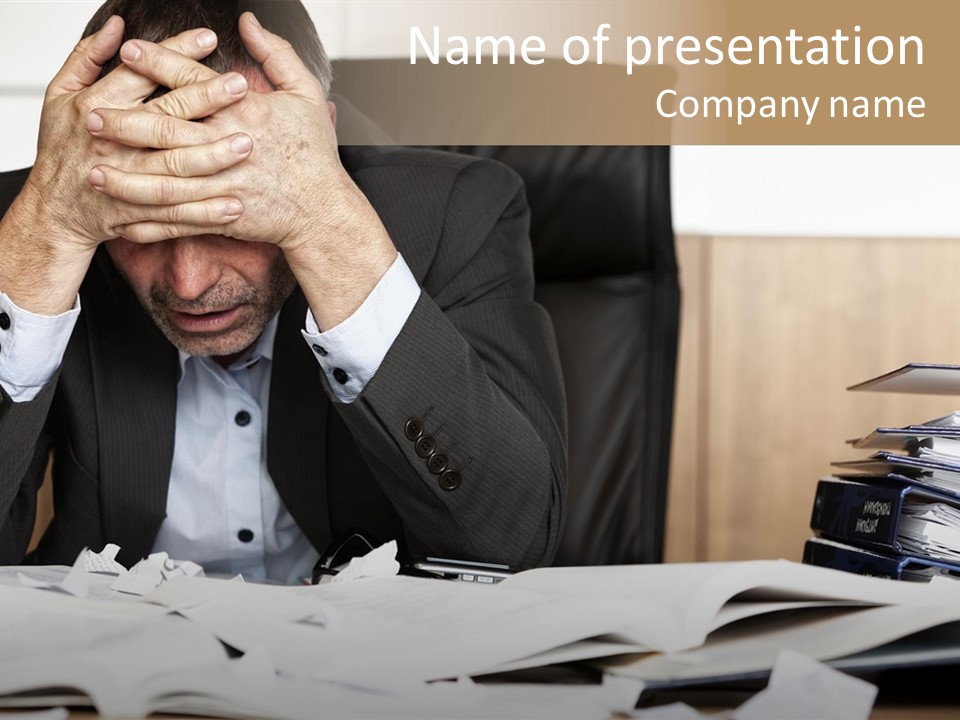A Man Sitting At A Desk With A Pile Of Papers In Front Of Him PowerPoint Template