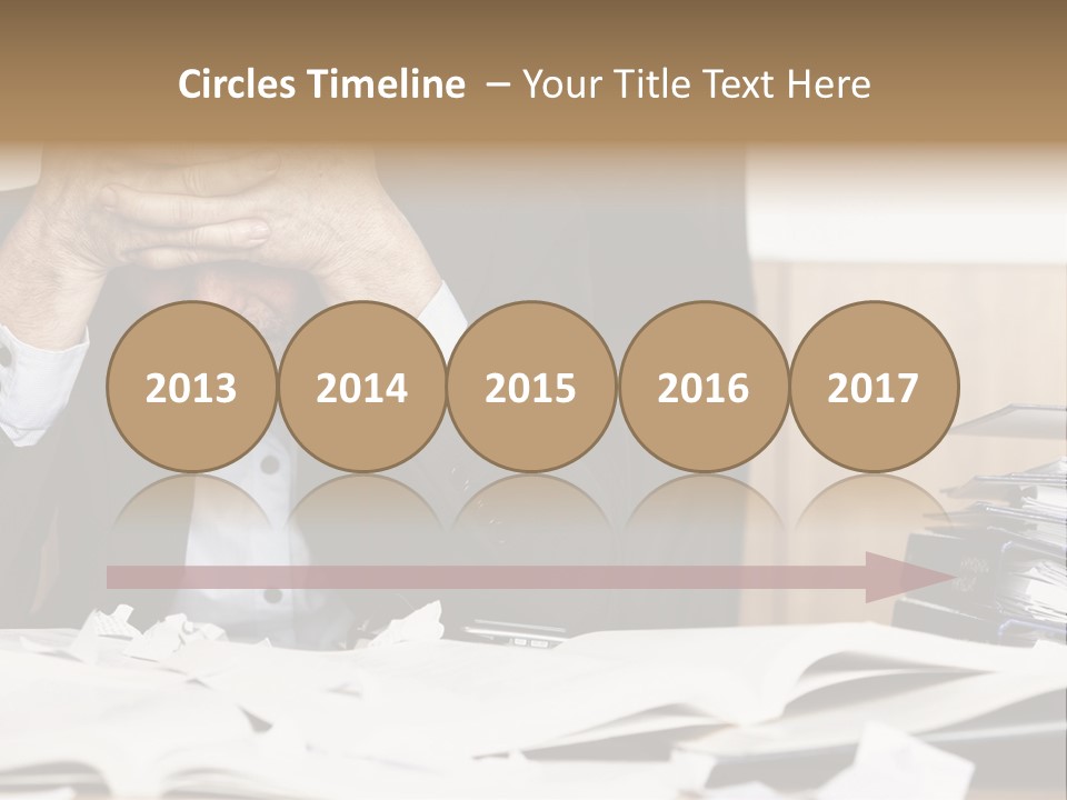 A Man Sitting At A Desk With A Pile Of Papers In Front Of Him PowerPoint Template