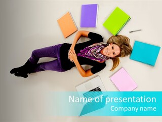 A Woman Laying On The Floor Surrounded By Notebooks PowerPoint Template