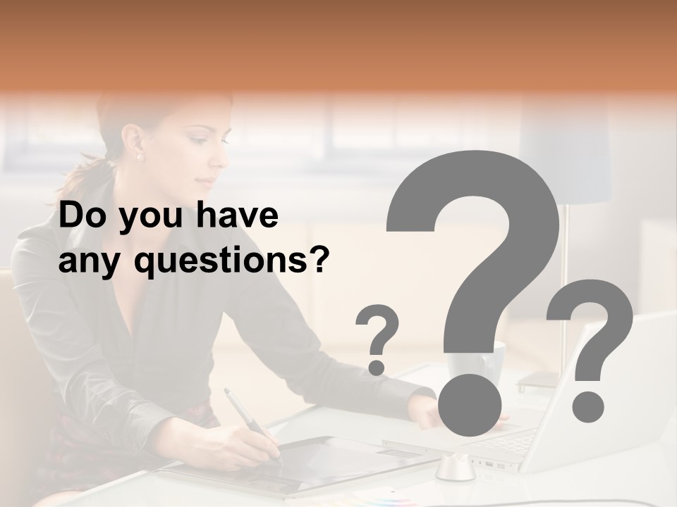 A Woman Sitting At A Desk Using A Laptop Computer PowerPoint Template