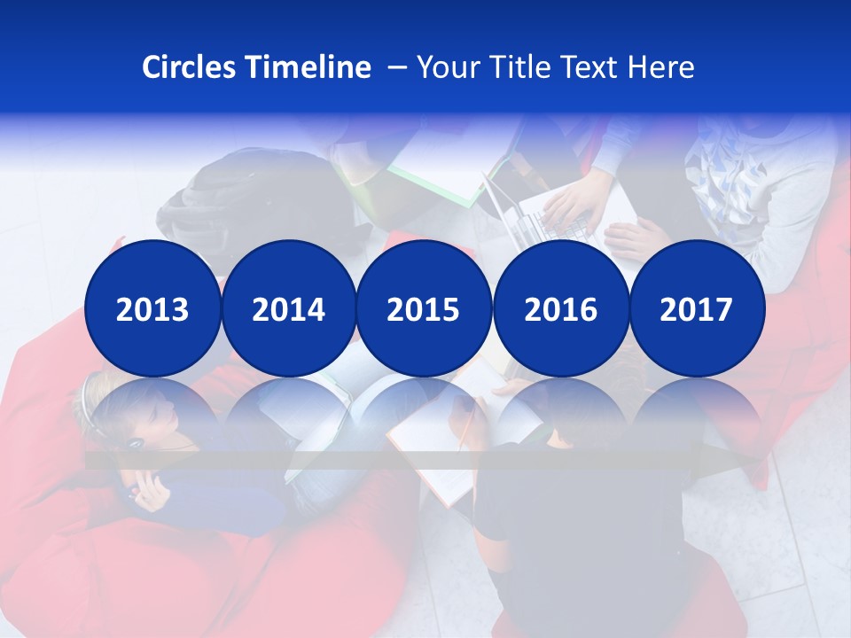 A Group Of People Sitting On Bean Bag Chairs Working On Laptops PowerPoint Template