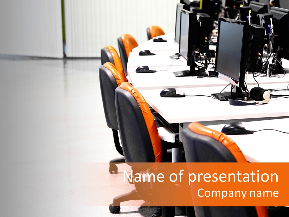 A Row Of Computer Monitors Sitting On Top Of A Table PowerPoint Template