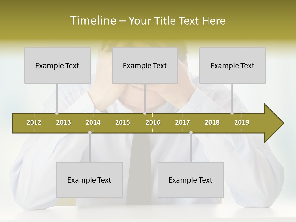 A Man Sitting At A Desk With His Hands On His Head PowerPoint Template
