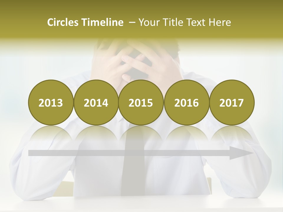 A Man Sitting At A Desk With His Hands On His Head PowerPoint Template