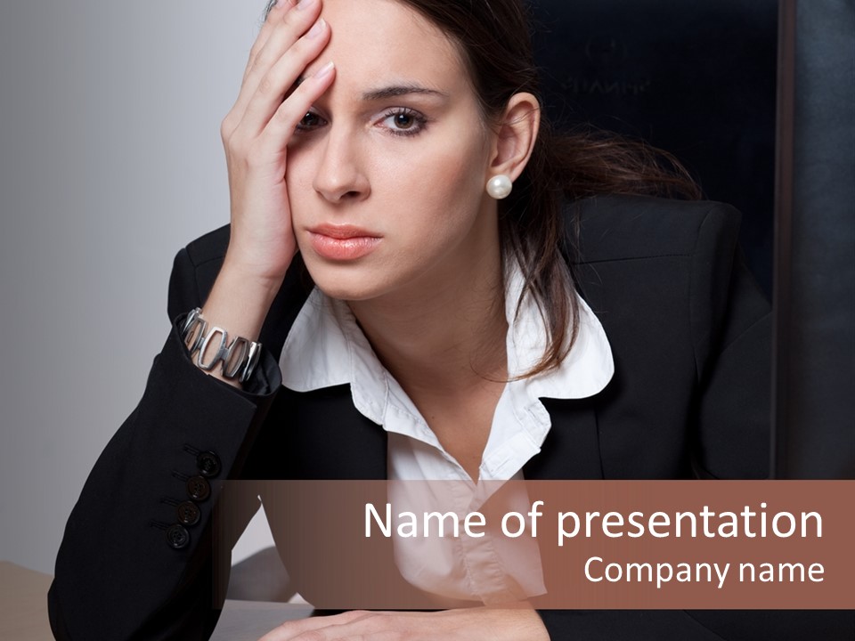 A Woman Sitting At A Desk With Her Hand On Her Head PowerPoint Template