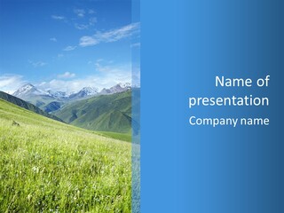 A Green Field With Mountains In The Background PowerPoint Template