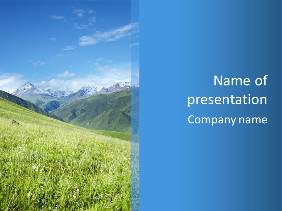 A Green Field With Mountains In The Background PowerPoint Template