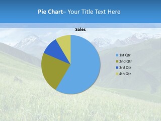 A Green Field With Mountains In The Background PowerPoint Template