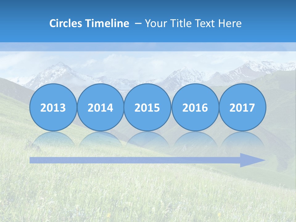 A Green Field With Mountains In The Background PowerPoint Template