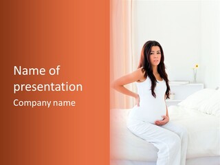 A Pregnant Woman Sitting On A Bed With Her Hands On Her Hips PowerPoint Template