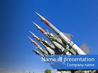 A Group Of Missiles On Display In Front Of A Blue Sky PowerPoint Template