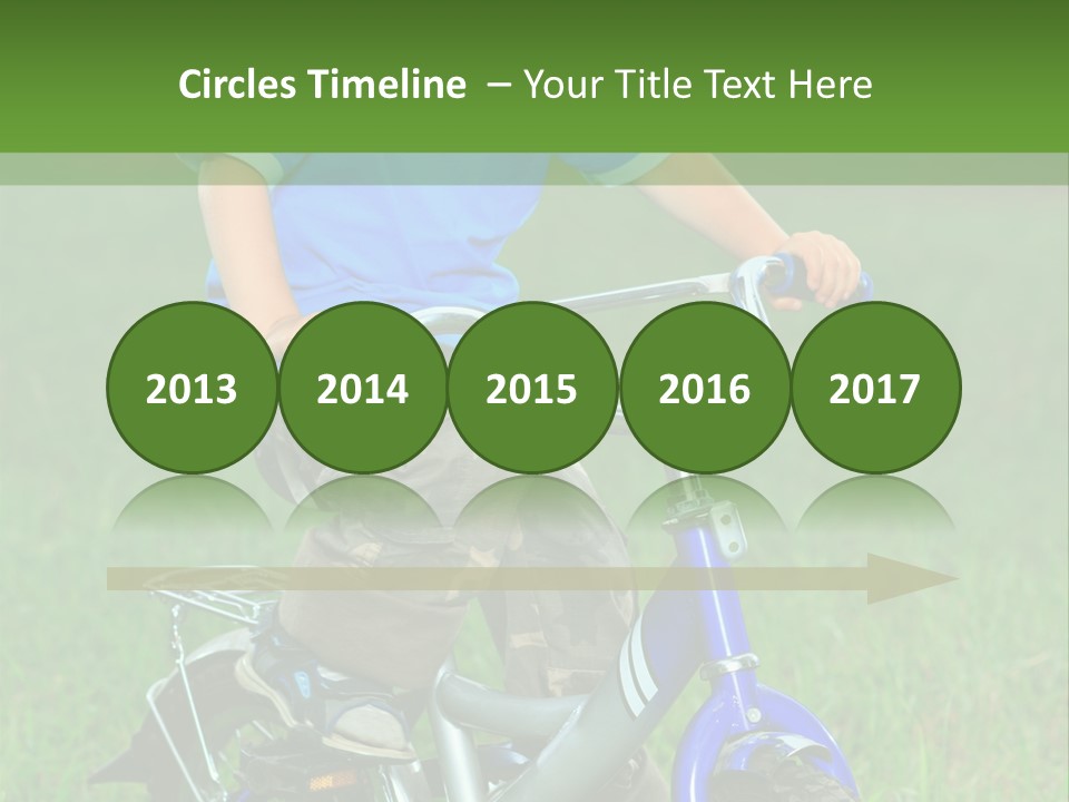 A Young Boy Is Riding A Bike In The Grass PowerPoint Template