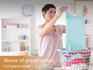 A Woman Holding A Blue Shirt In Front Of A Laundry Basket PowerPoint Template
