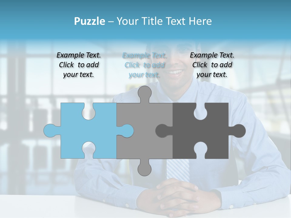 A Man In A Blue Shirt And Tie Sitting At A Table PowerPoint Template