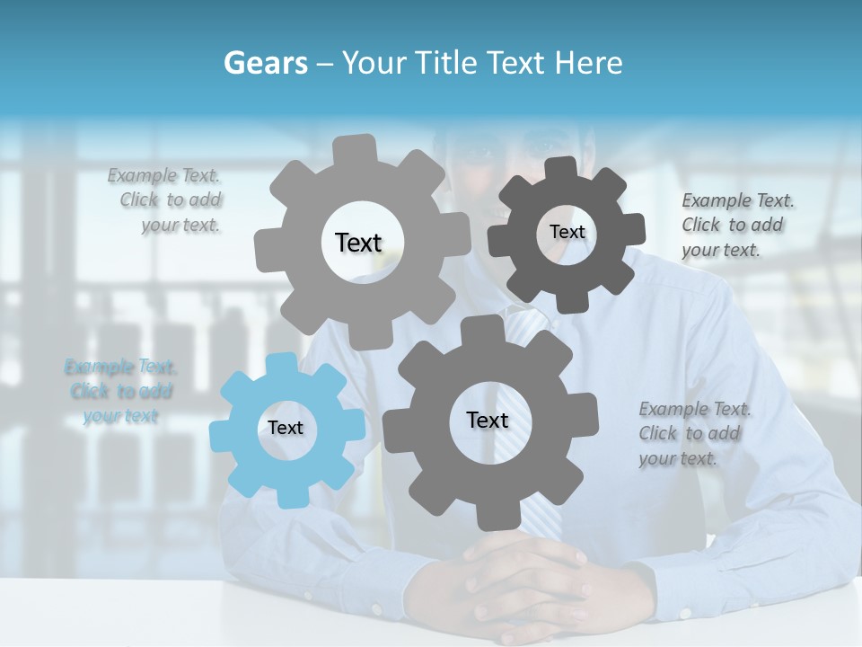 A Man In A Blue Shirt And Tie Sitting At A Table PowerPoint Template