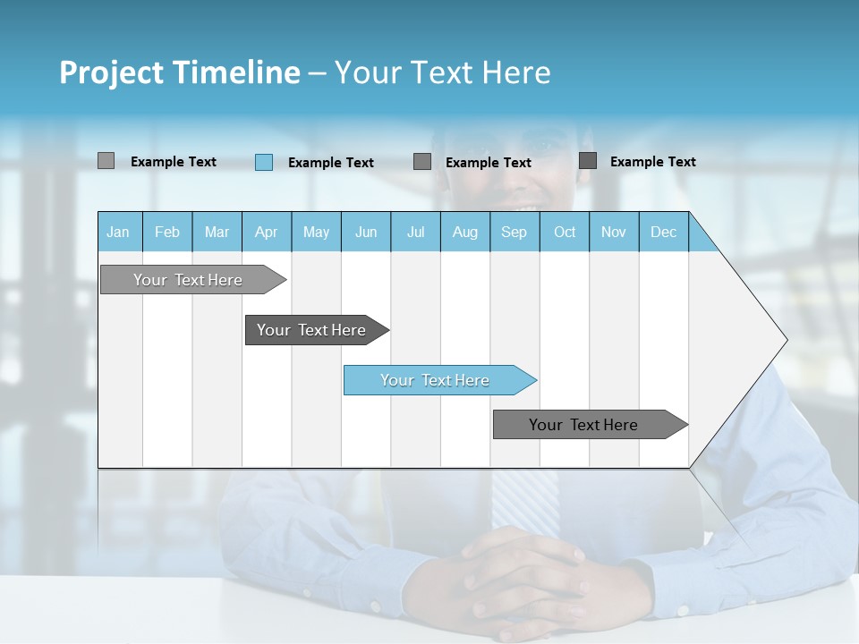 A Man In A Blue Shirt And Tie Sitting At A Table PowerPoint Template