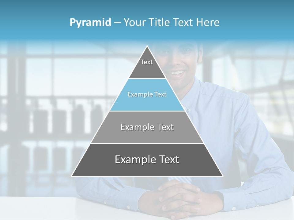 A Man In A Blue Shirt And Tie Sitting At A Table PowerPoint Template